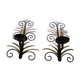 Wrought iron sconces decorated with golden pineapple leaves