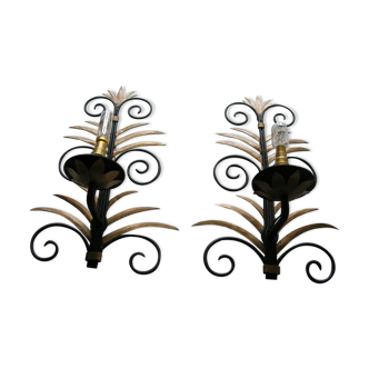 Wrought iron sconces decorated with golden pineapple leaves