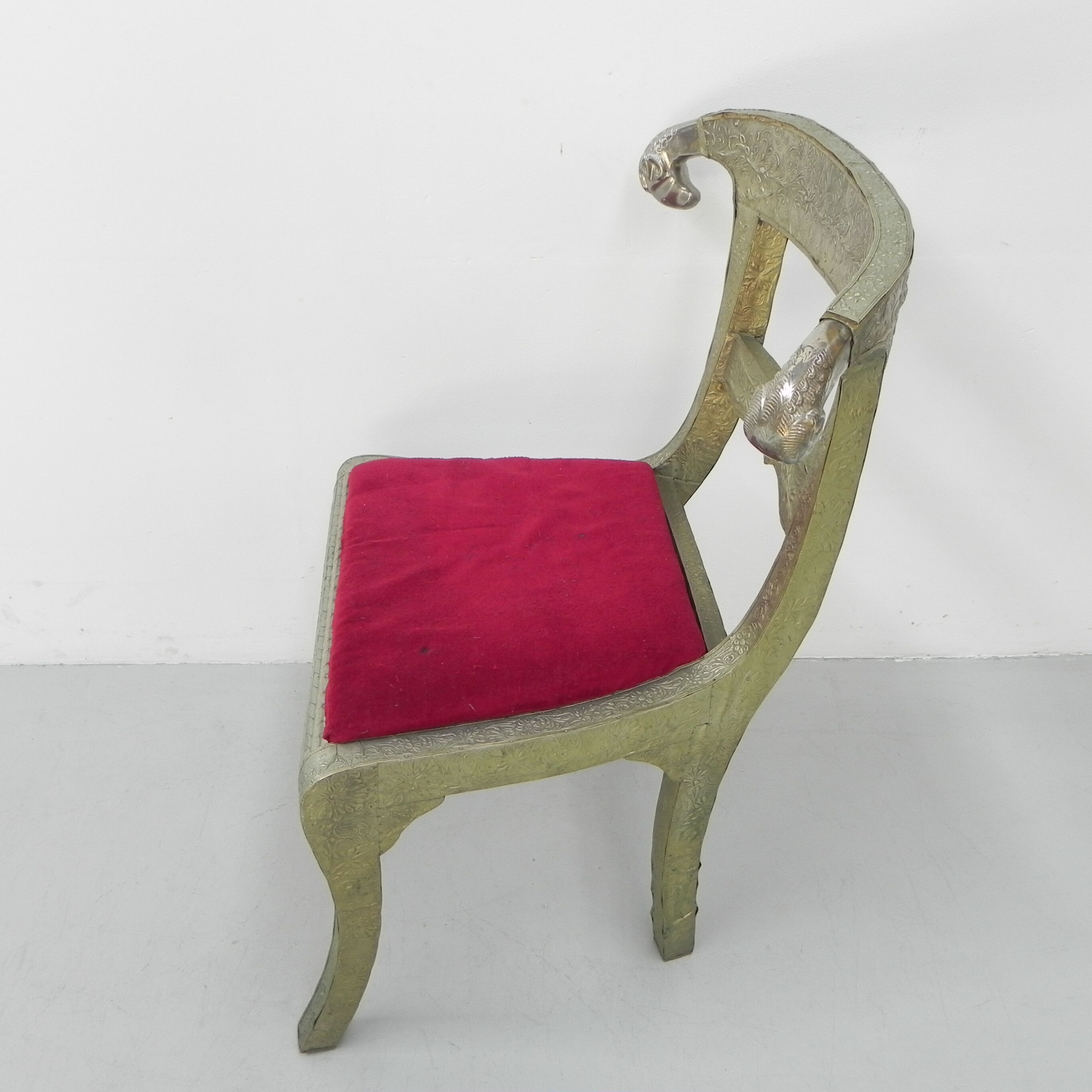 Dining chair upholstered with stamped tin