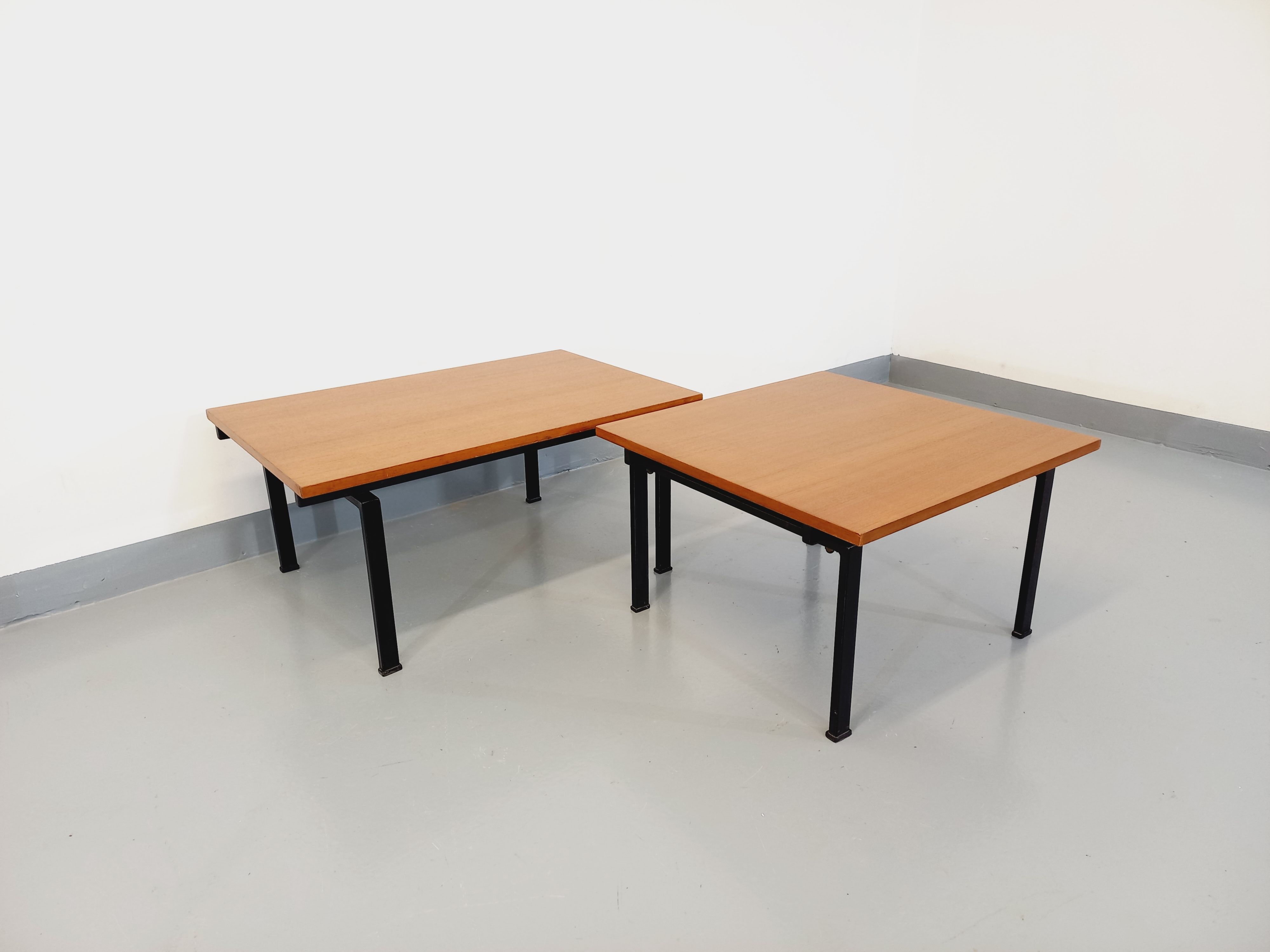 Suite of two vintage modernist Isa coffee tables in teak and black metal from the 60s