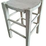 Vintage wooden stool with white peeling paint