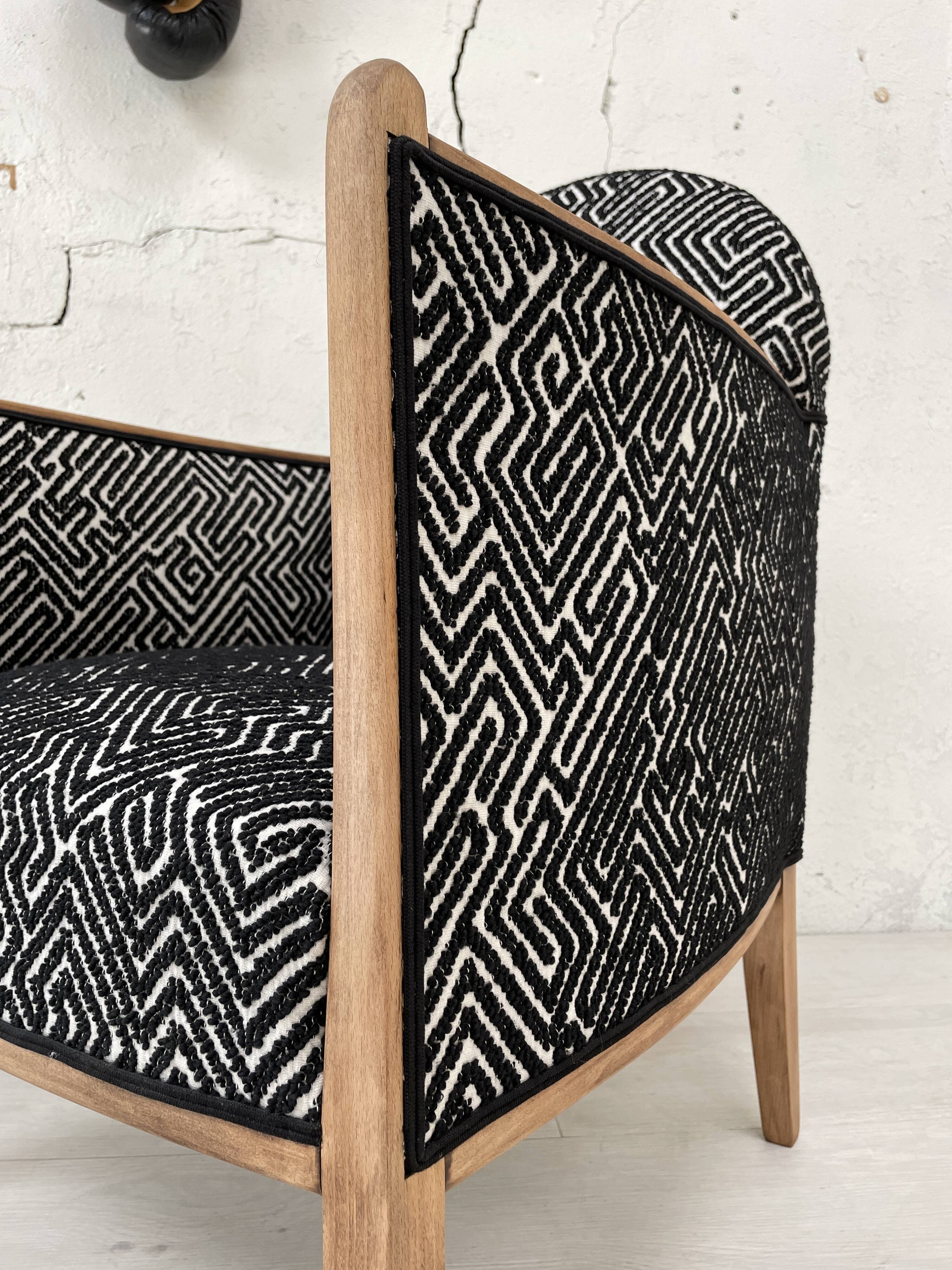 Club armchair in wood and fabric.