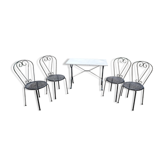 White marble table and 4 wrought iron chairs.