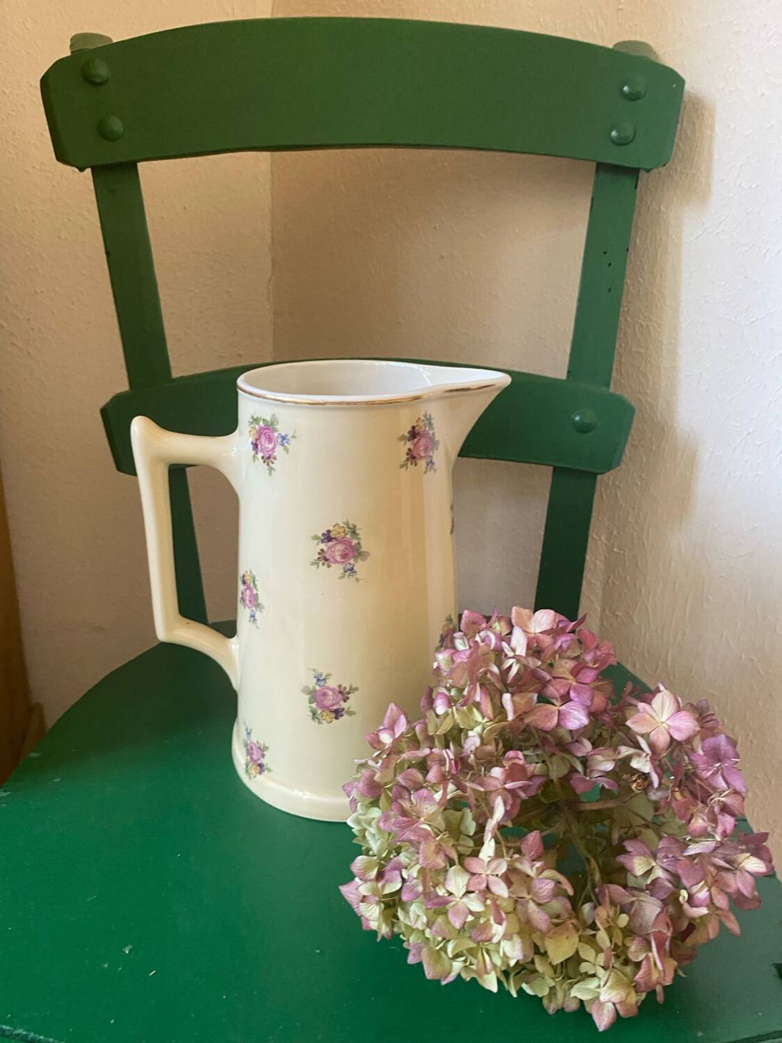 Old flowery and gilded pitcher.