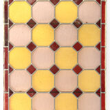 Old stained glass window with geometric patterns
