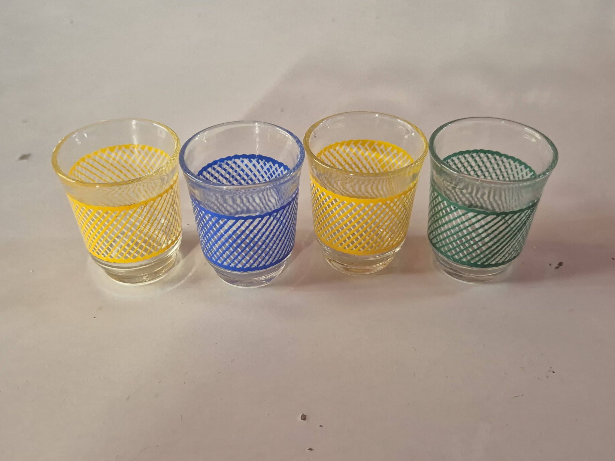 set of 4 vintage liqueur glasses in yellow, green, and blue