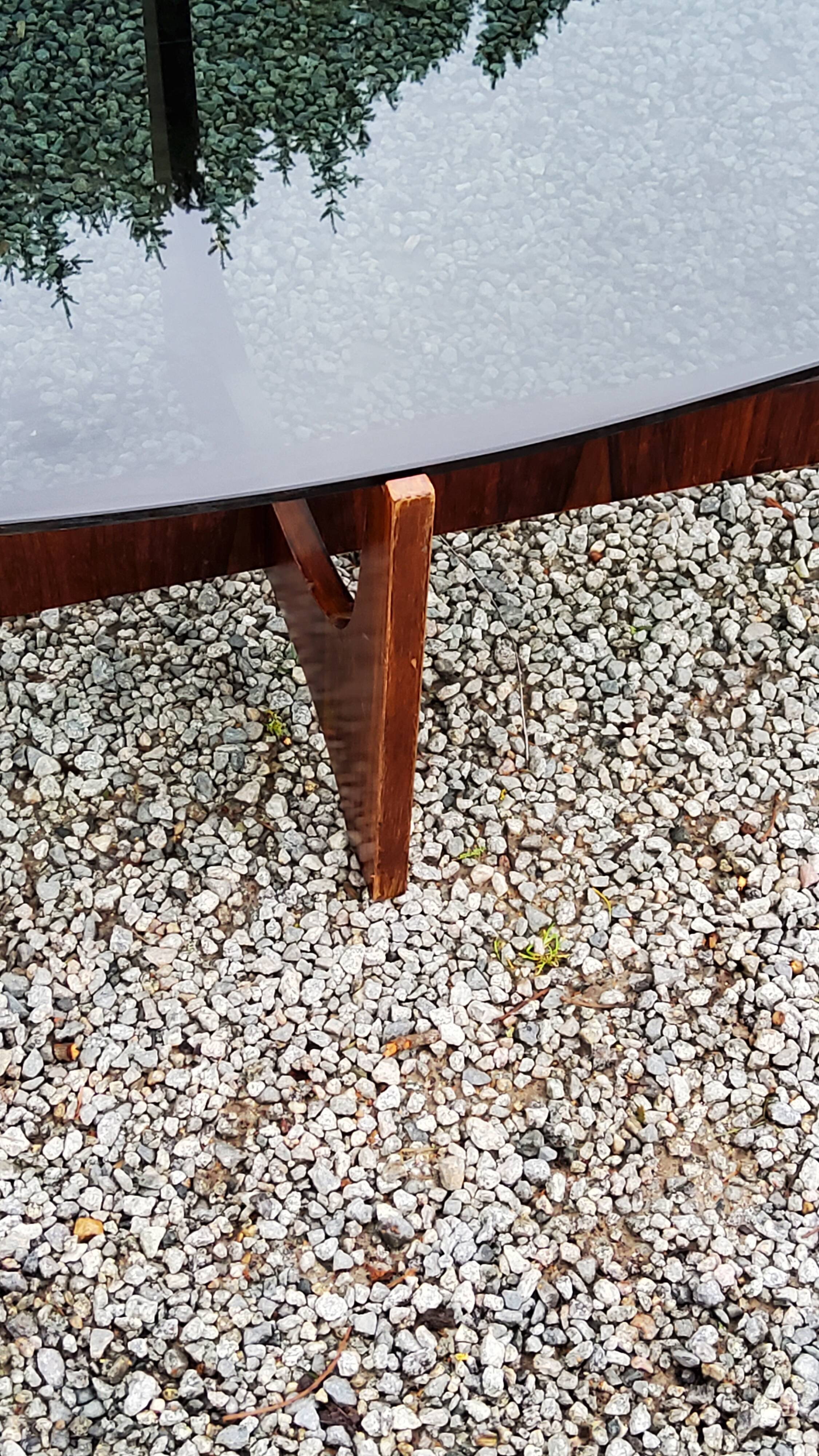 Designer coffee table by Hugues Poignant in rosewood and smoked glass from the 70s