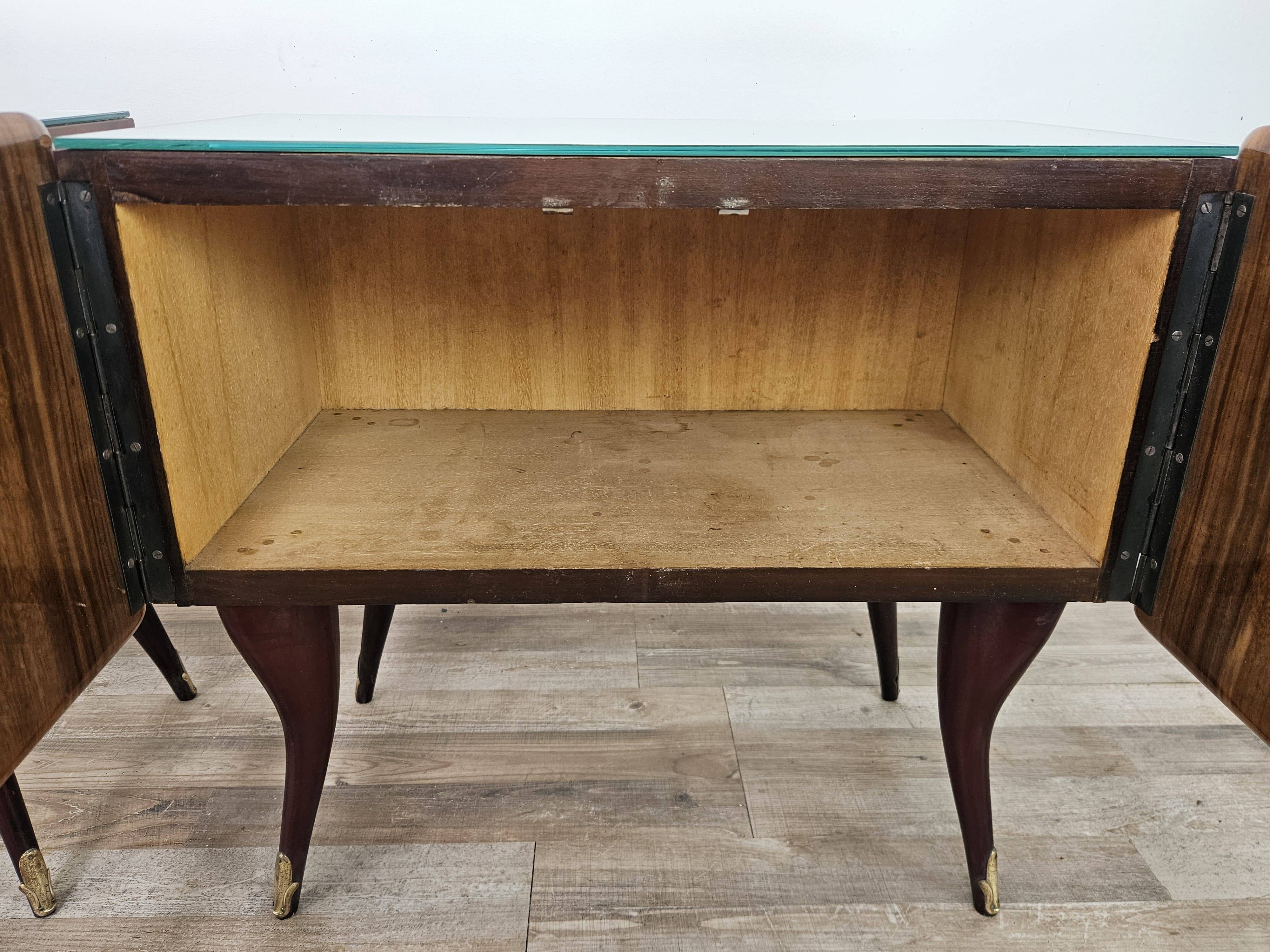 Mid-century mahogany bedside tables with mirrored tops.