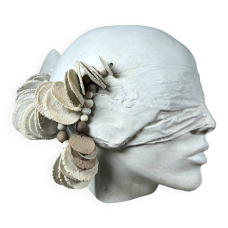 Stylized head in white biscuit, artist's work