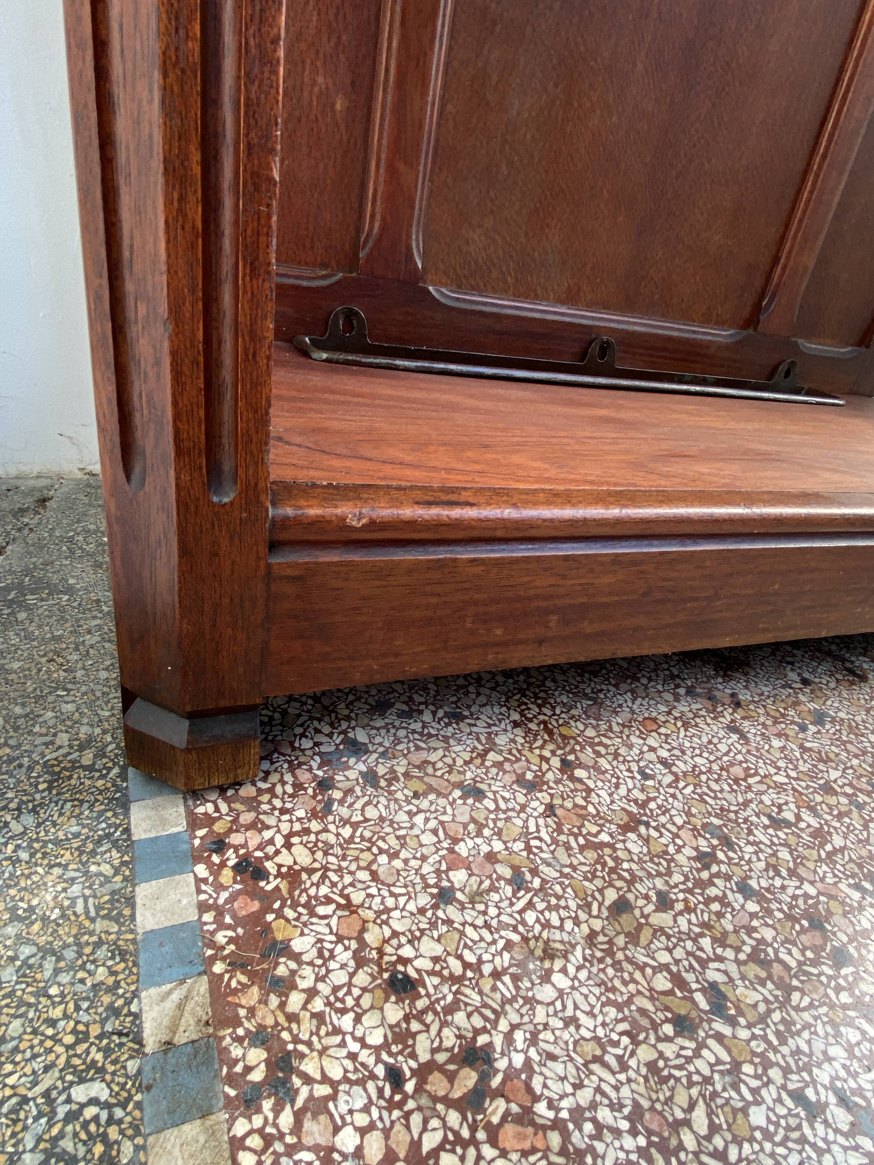 Antique wooden coat rack with mirror and shelf.