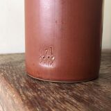 Old bottle in hazelnut Brown sandstone with label