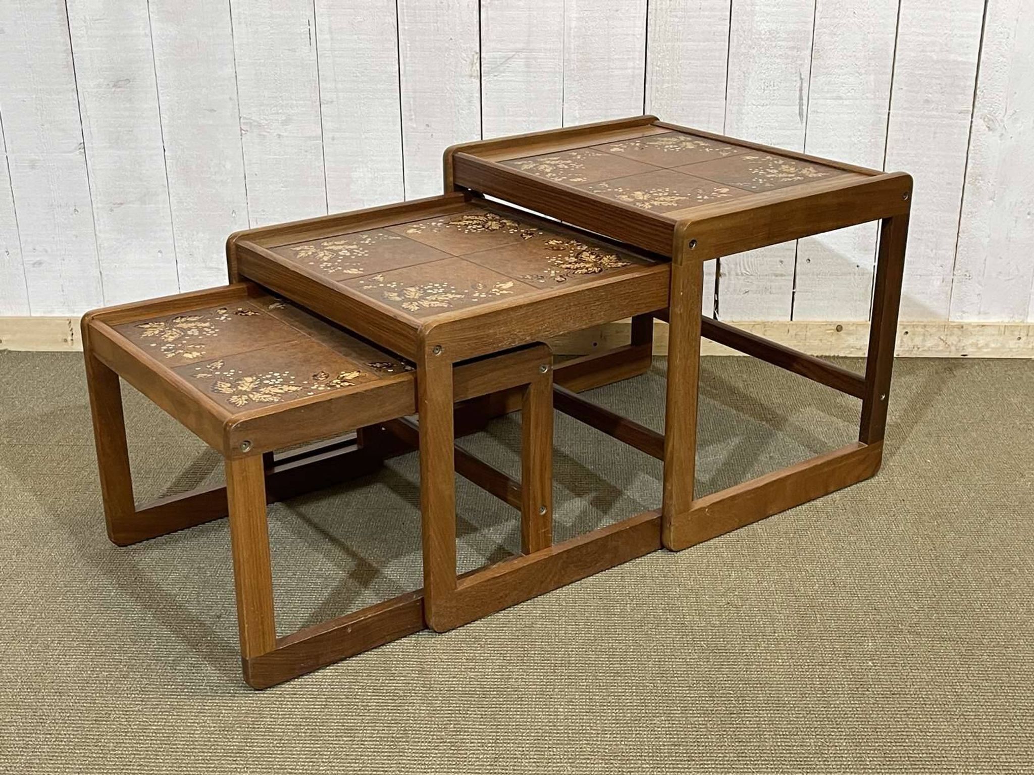 Set of 3 nesting tables in teak with tiled tops.