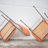 Pair of chrome metal chair and orange skai