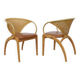 Pair of leather and rattan chairs by Lübke