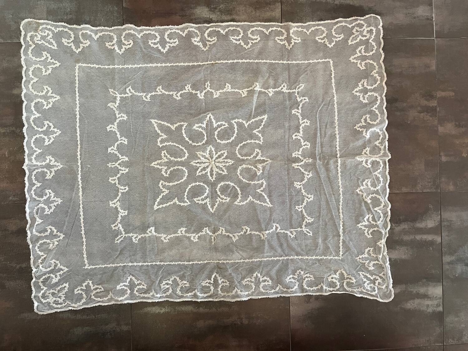 Old tablecloth embroidered with openwork embroidery.