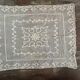 Old tablecloth embroidered with openwork embroidery.