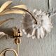 Wall lamp in gilded brass with a daisy design.