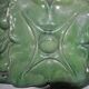 Green enamelled ceramic stove tile — finely sculpted Hungarian pattern from the late 19th century.