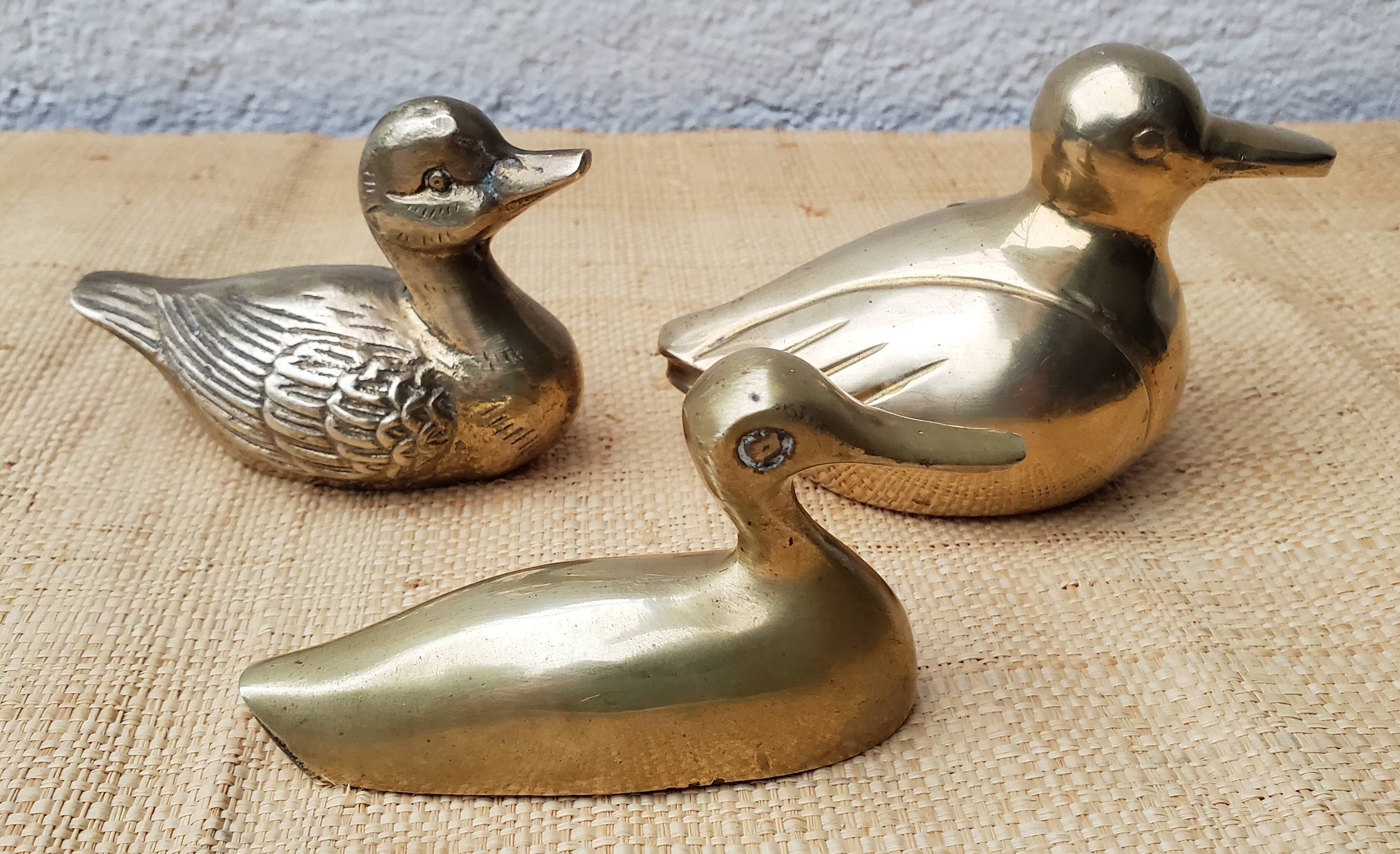 Trio of brass ducks