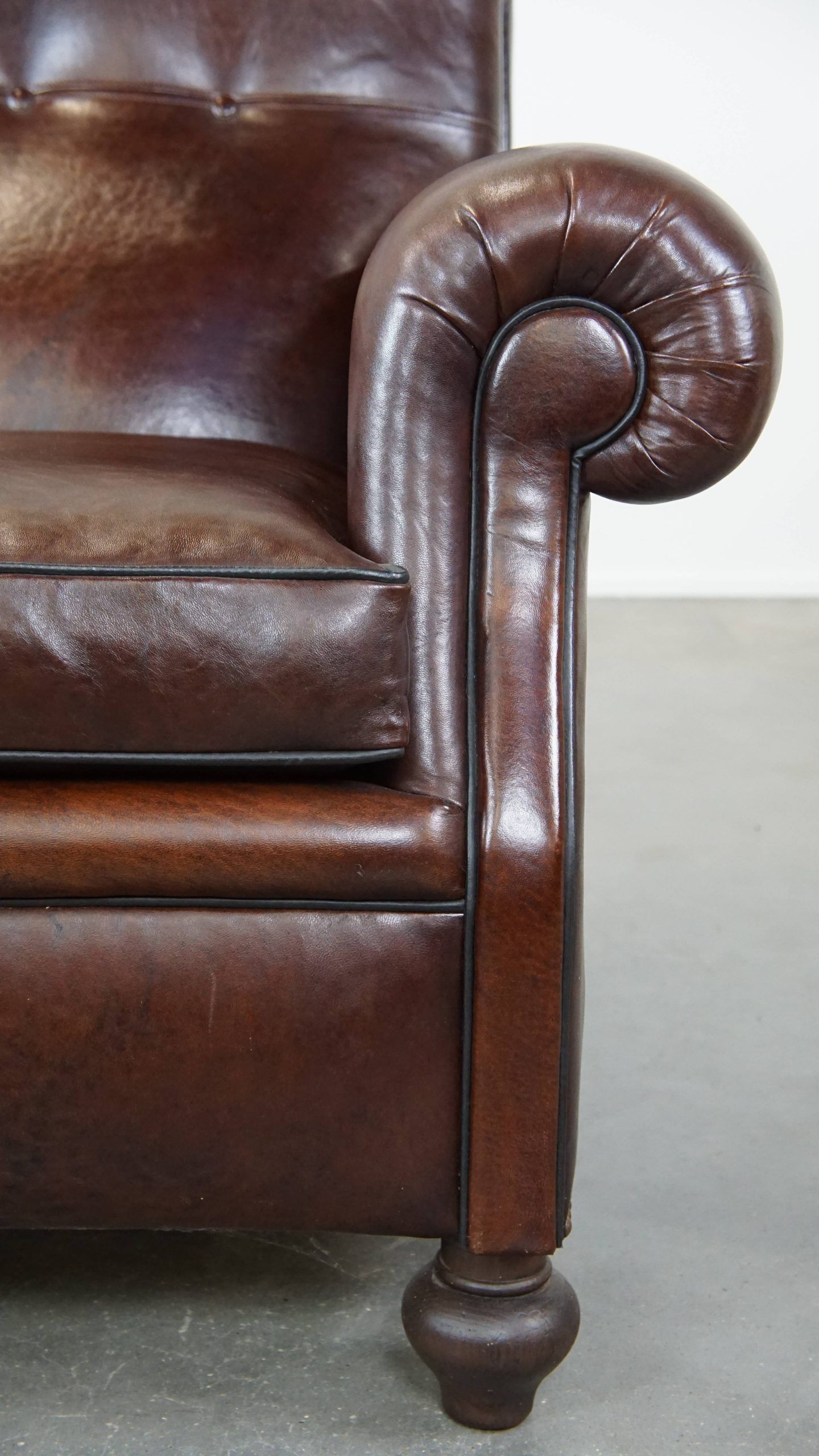 Comfortable and correct dark antique sheepskin English armchair in very good condition