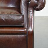 Comfortable and correct dark antique sheepskin English armchair in very good condition