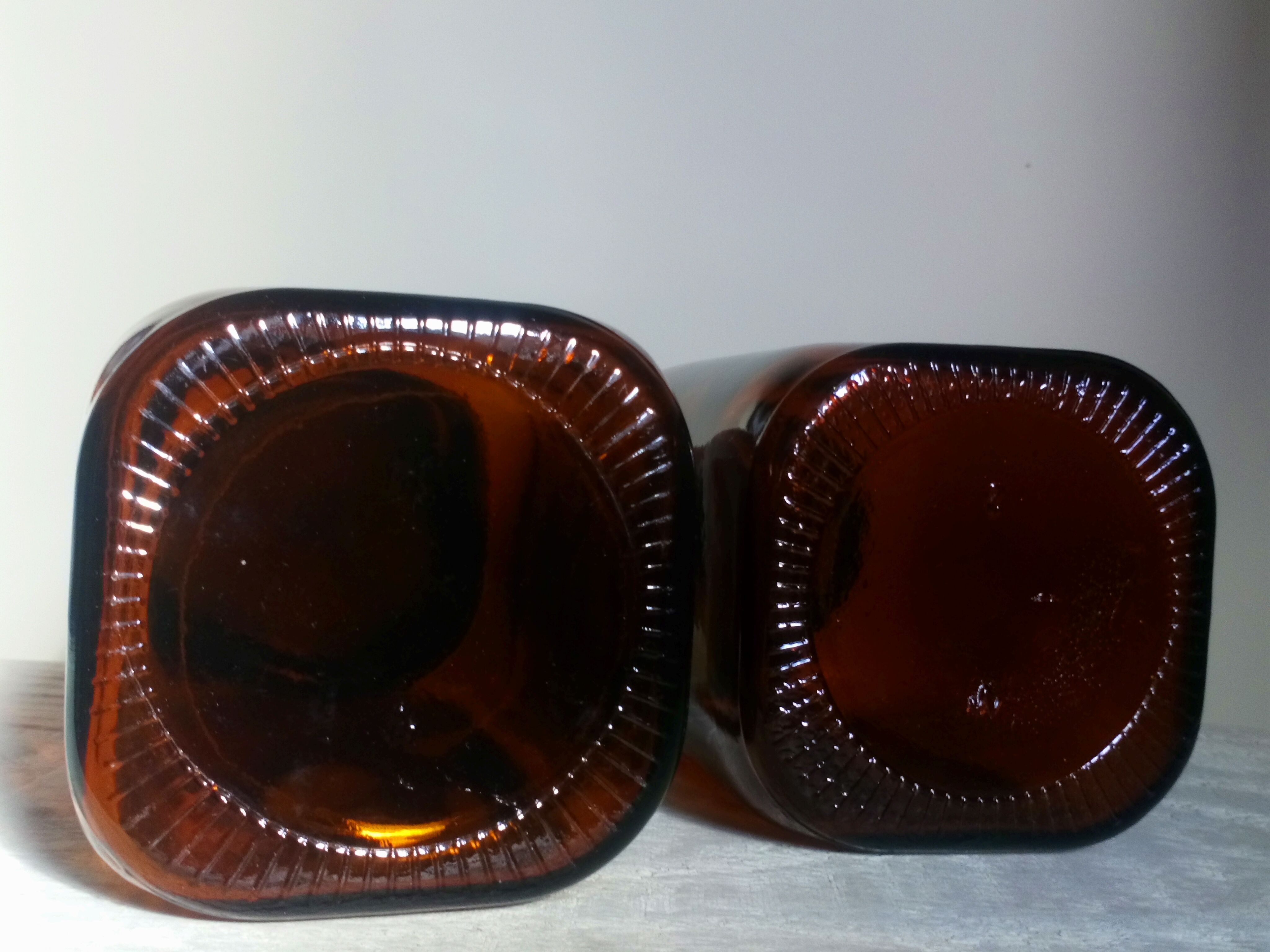 Duo of vintage apothecary bottles in amber glass