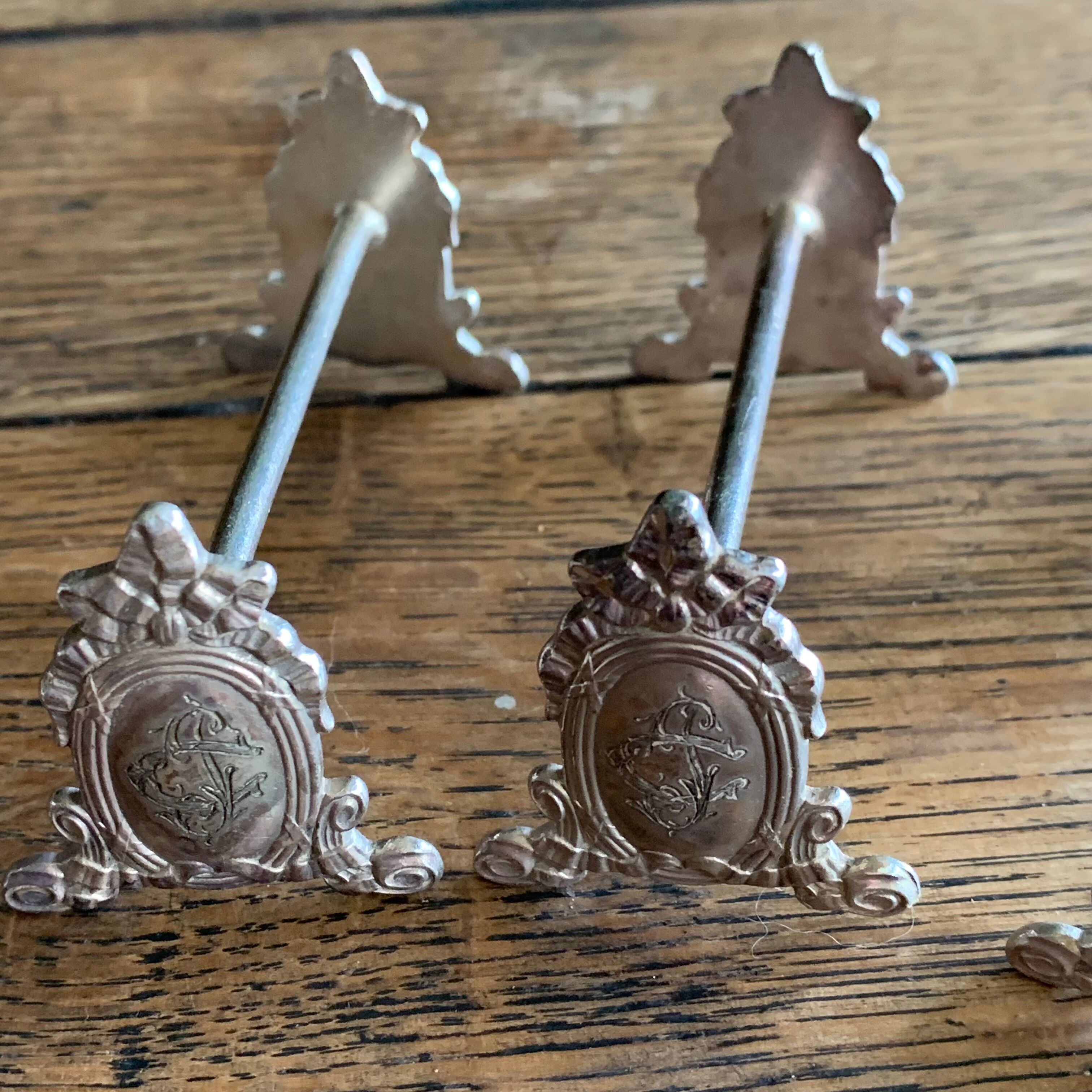 Series of 12 monogrammed silver metal knife holders