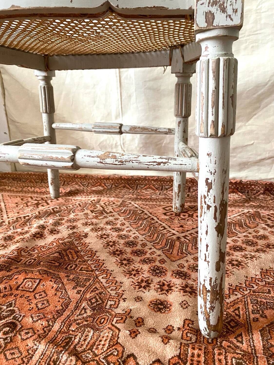 19th-century corner fireplace armchair, wood and cane.