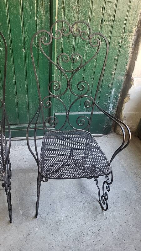 Pair of black wrought iron armchairs