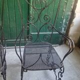 Pair of black wrought iron armchairs