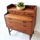 Mid-century teak dressing table in curved brown with sliding mirror and 6 drawers.