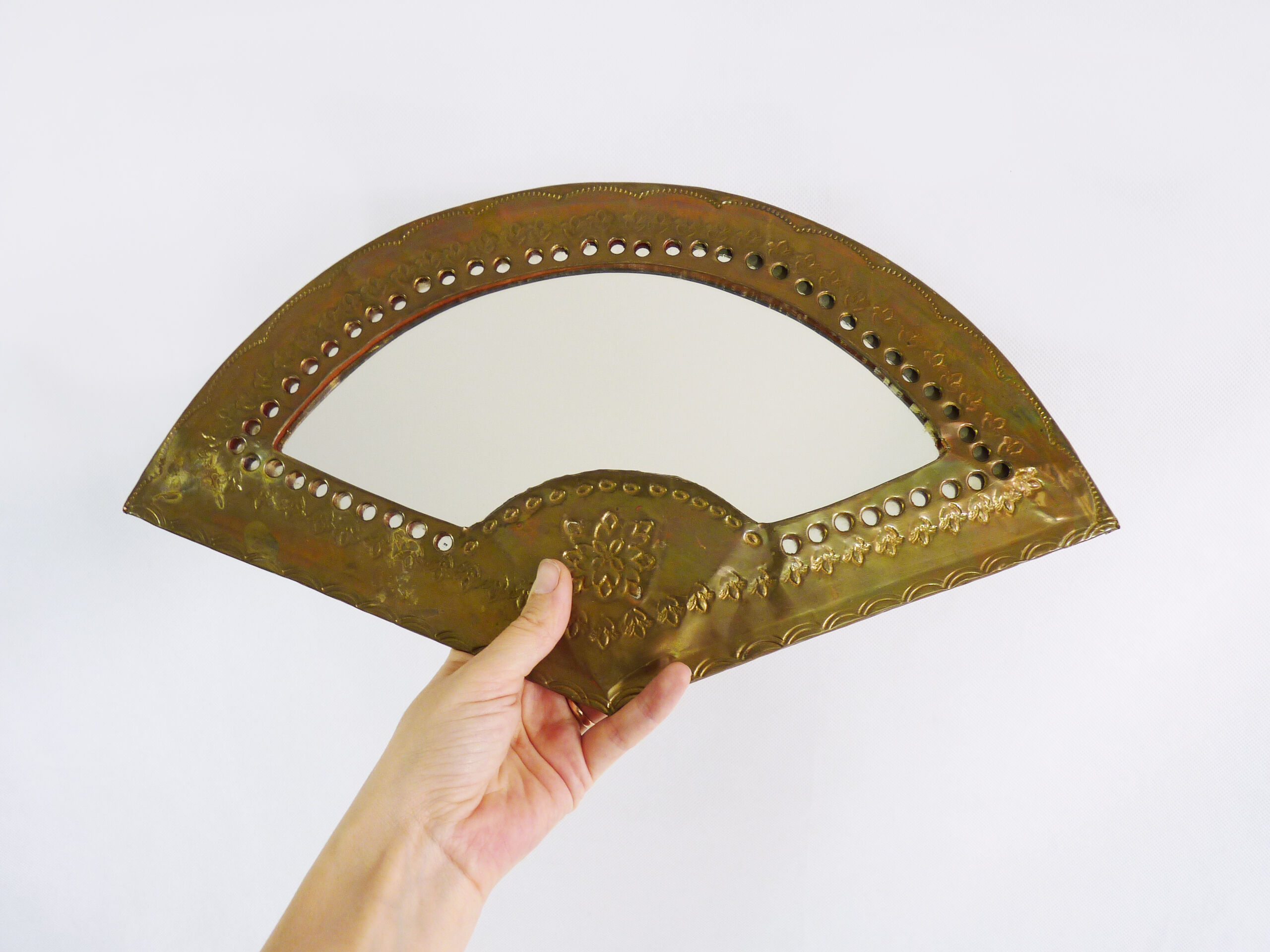 Old wall mirror in the shape of a copper fan pushed back, year 70