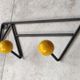 Two vintage metal and wood ball coat racks