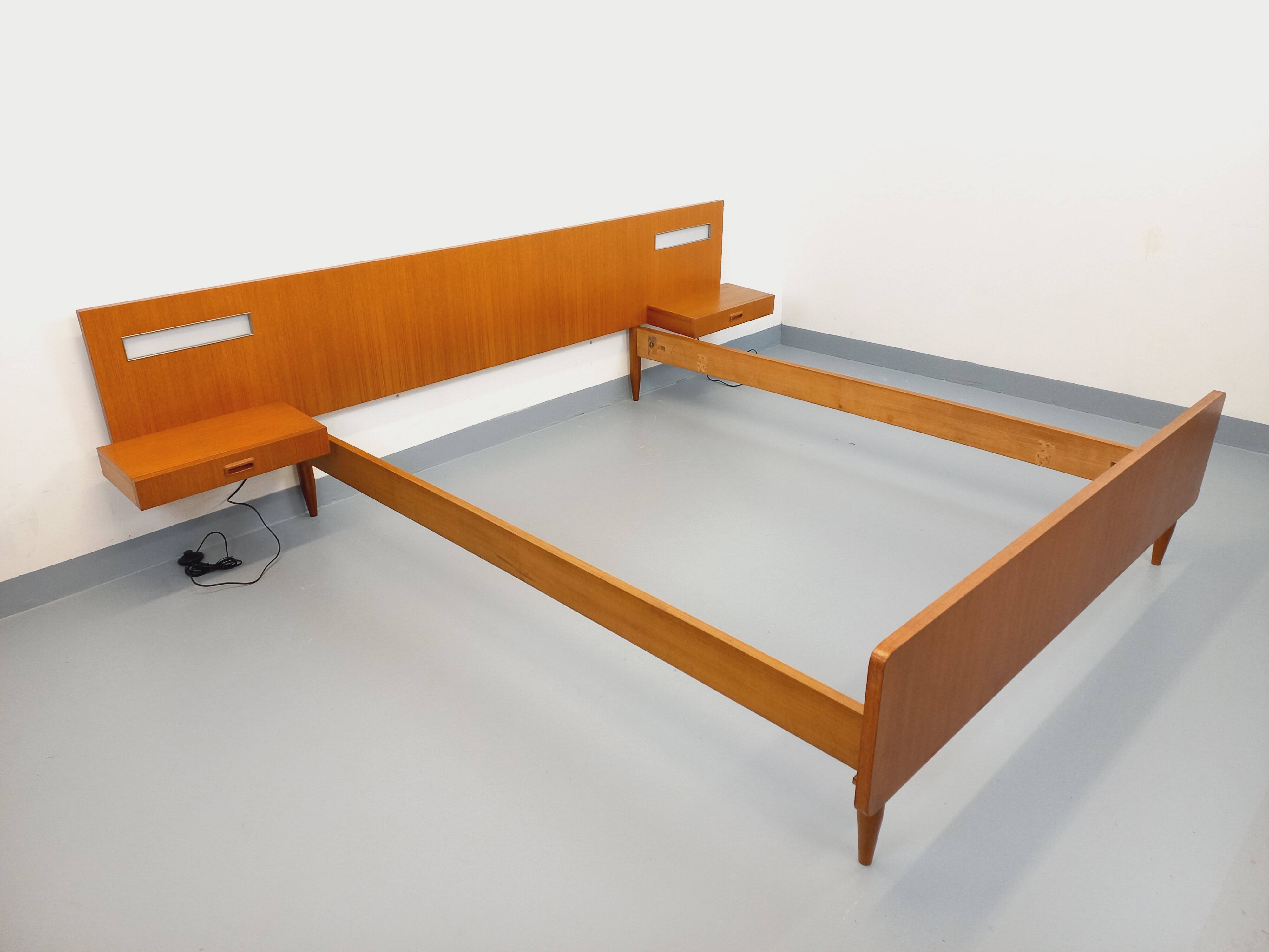 Double bed in vintage Scandinavian style from the 1960s with bedside tables.
