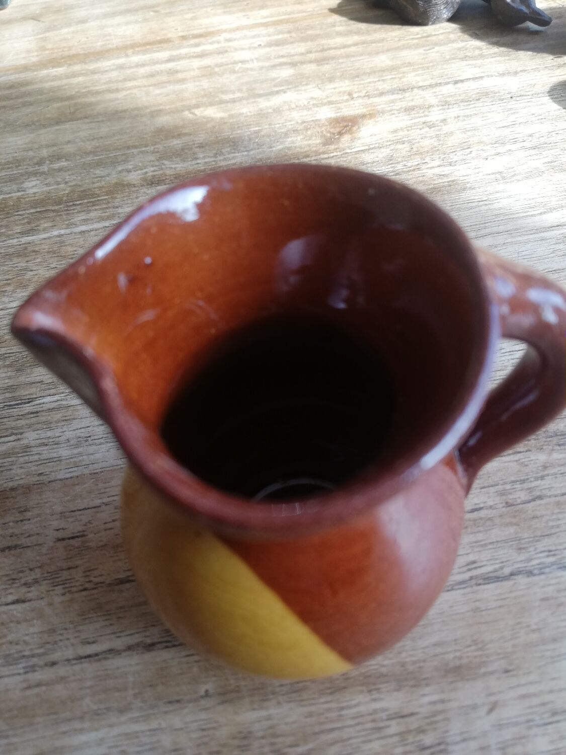 Small two-tone brown-yellow terracotta pitcher