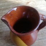 Small two-tone brown-yellow terracotta pitcher