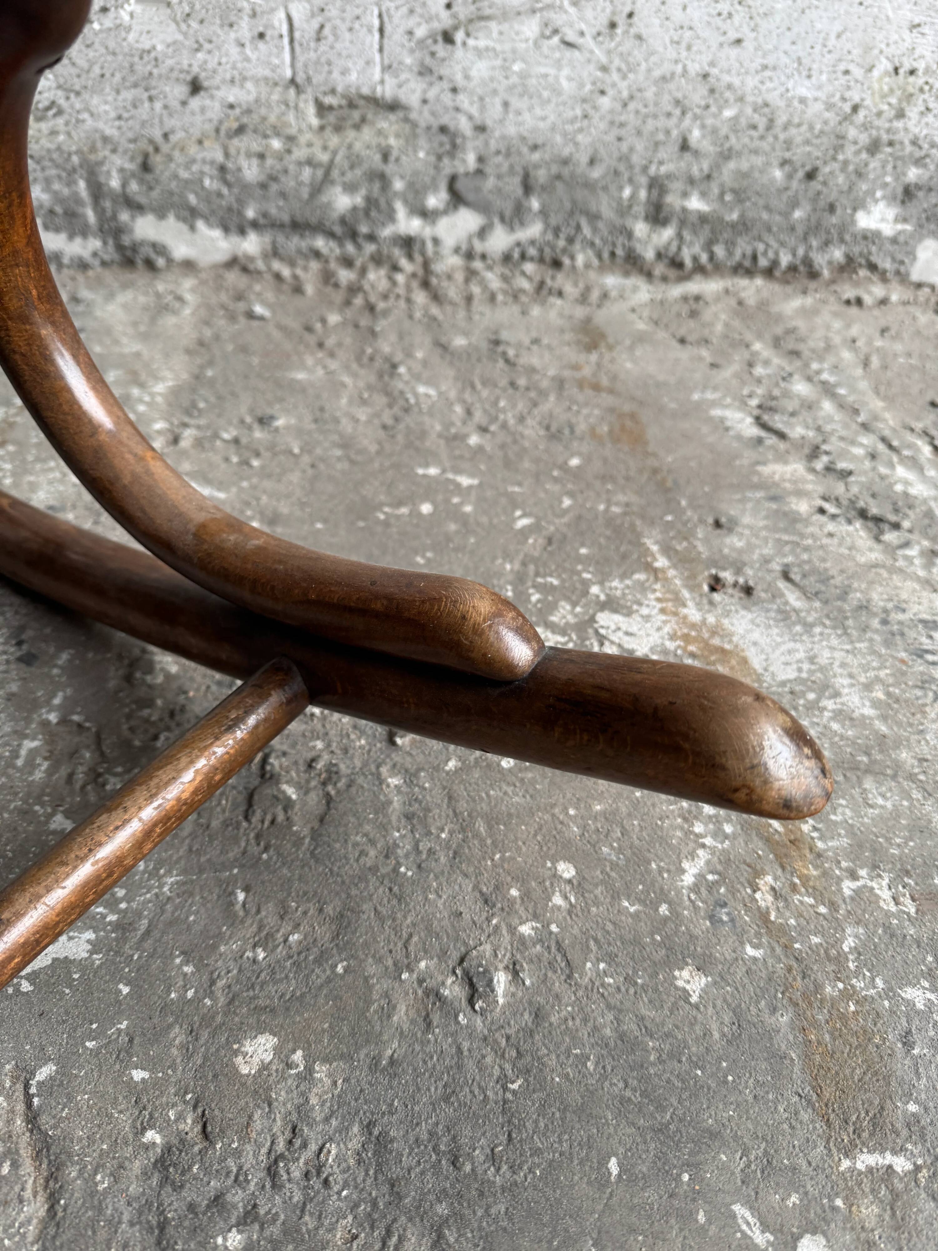 Warm walnut bentwood and cane child's rocking chair early 20th-century