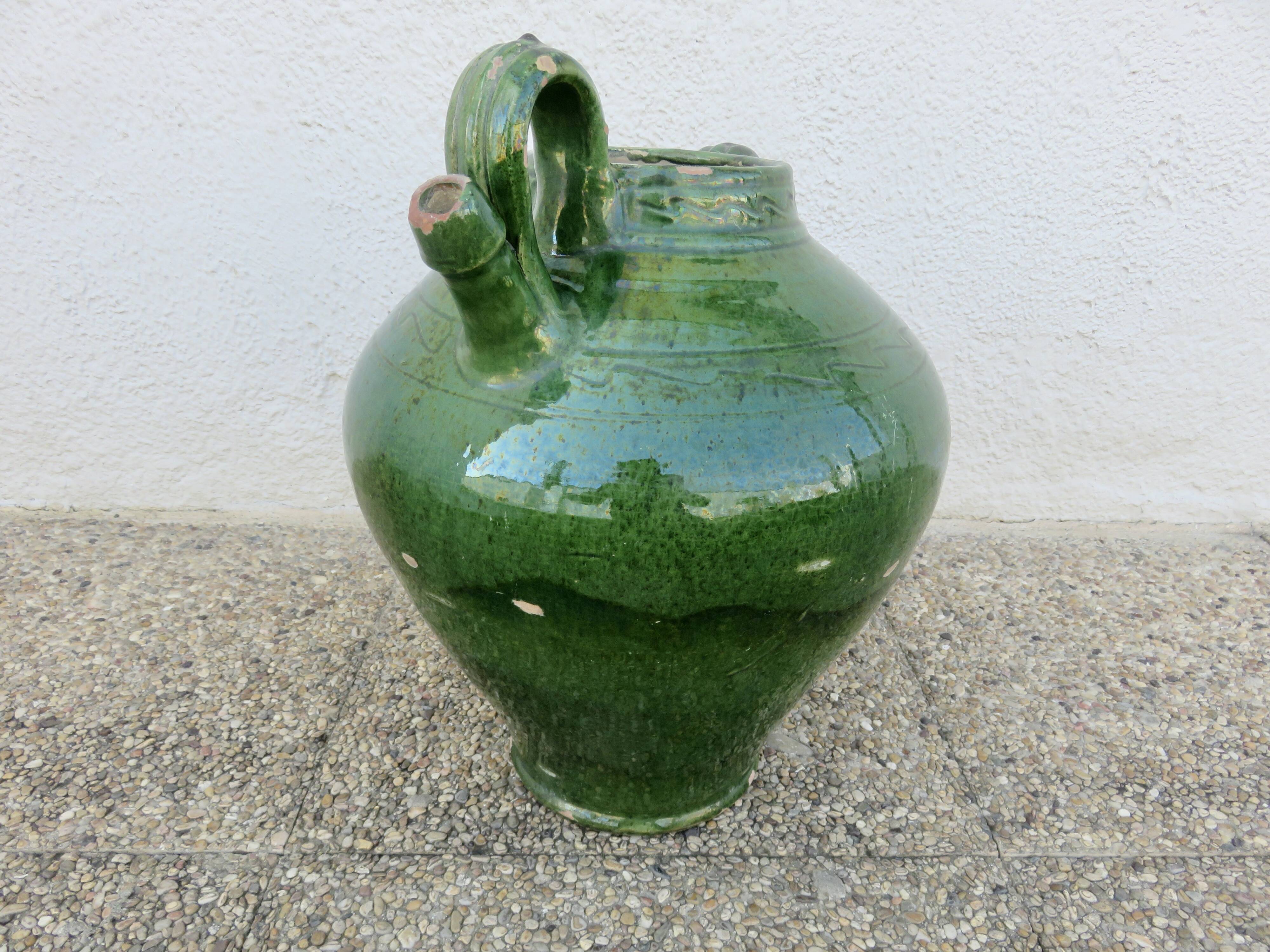 Antique glazed green terracotta oil jar, late 19th century.