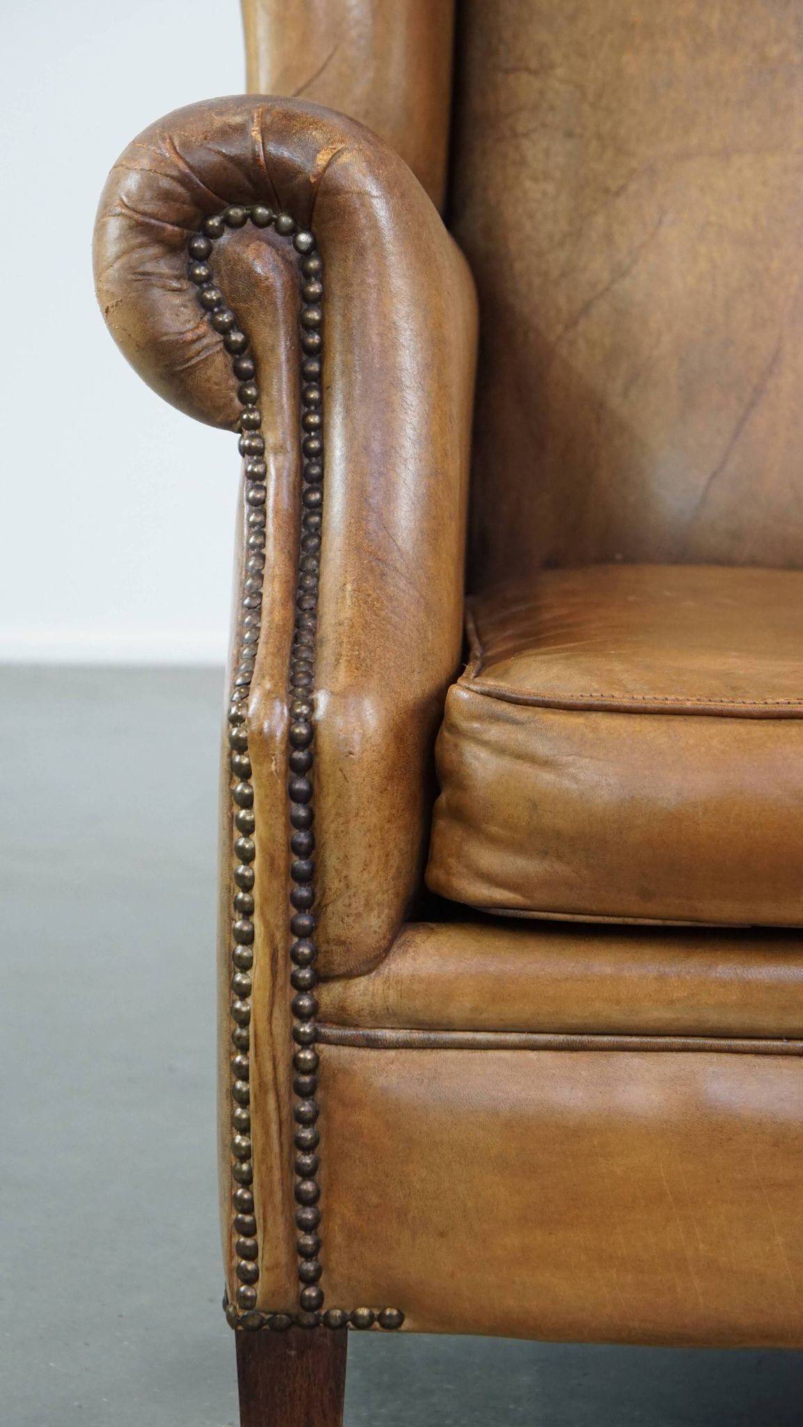 Patinated sheep leather wingback armchair
