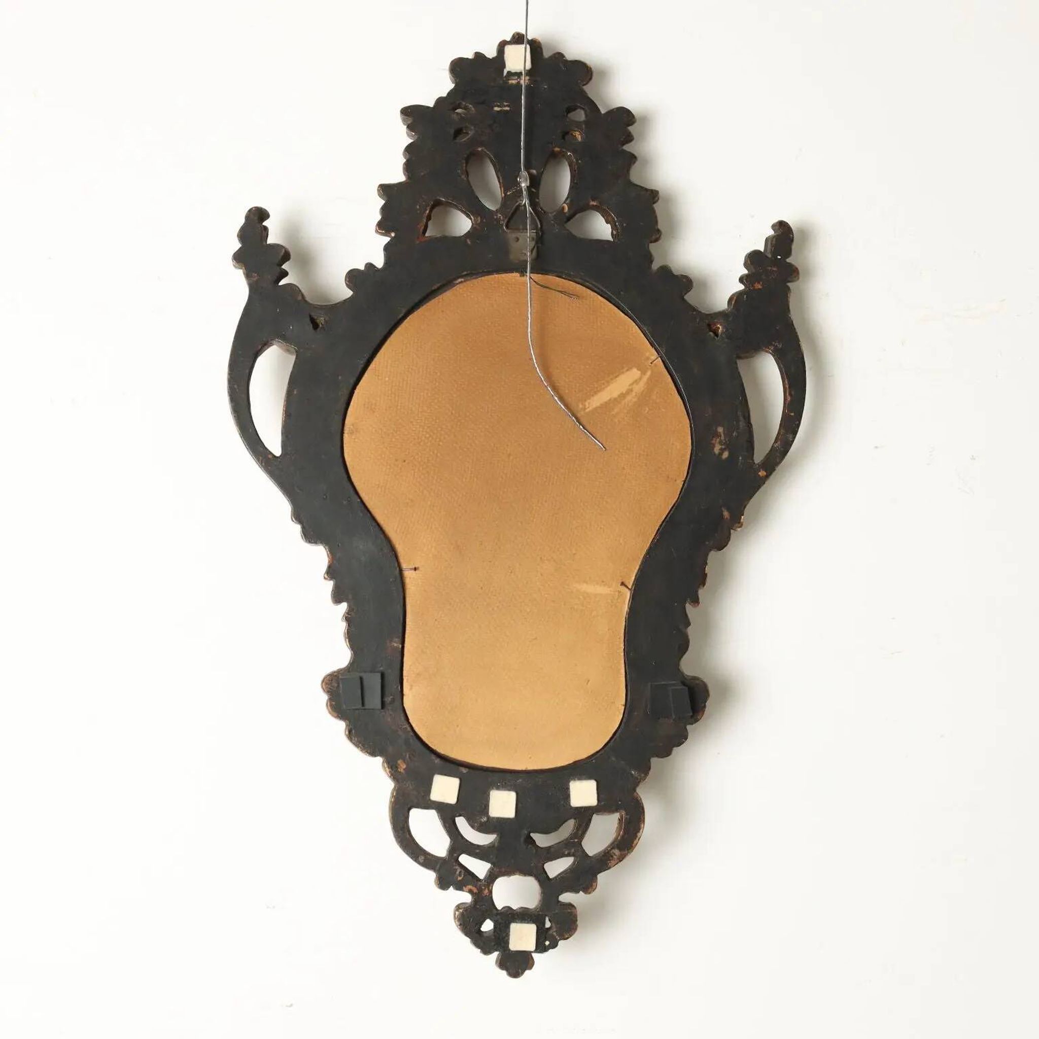 Antique Rococo-style mirror, gilded linden decorations, 20th century.