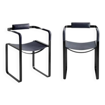 Pair of wanderlust armchairs in black and black metal.
