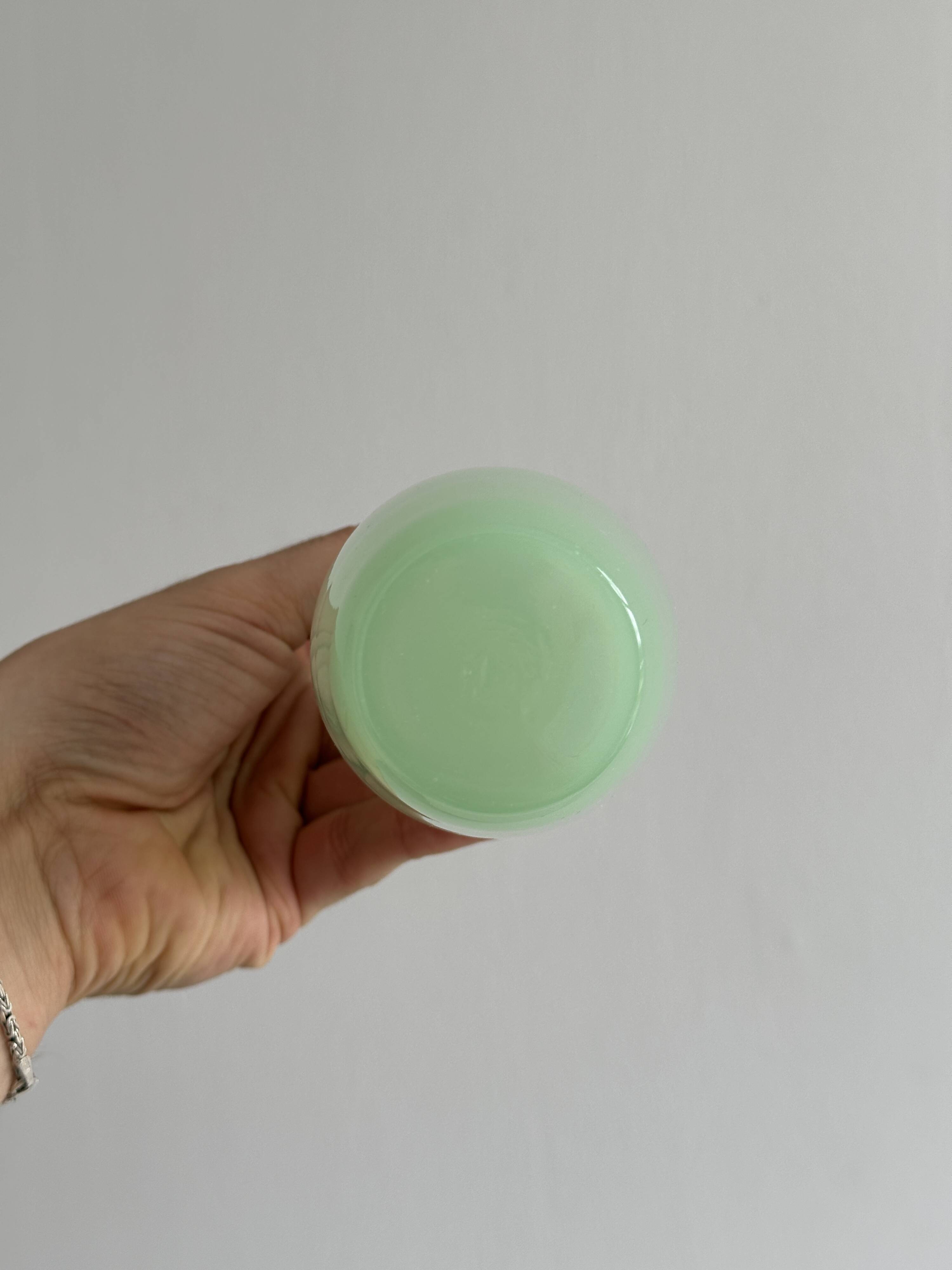 Opaque light green glass vial