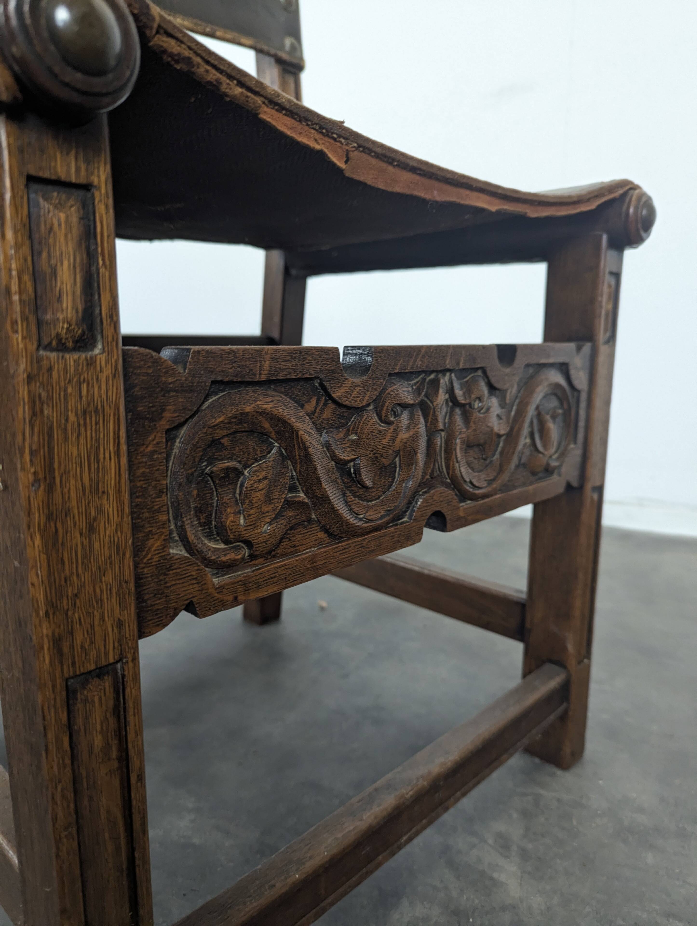 Set of 8 Gothic-style chairs in oak and studded leather.