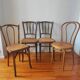 4 mismatched antique bistro chairs in wood and caning