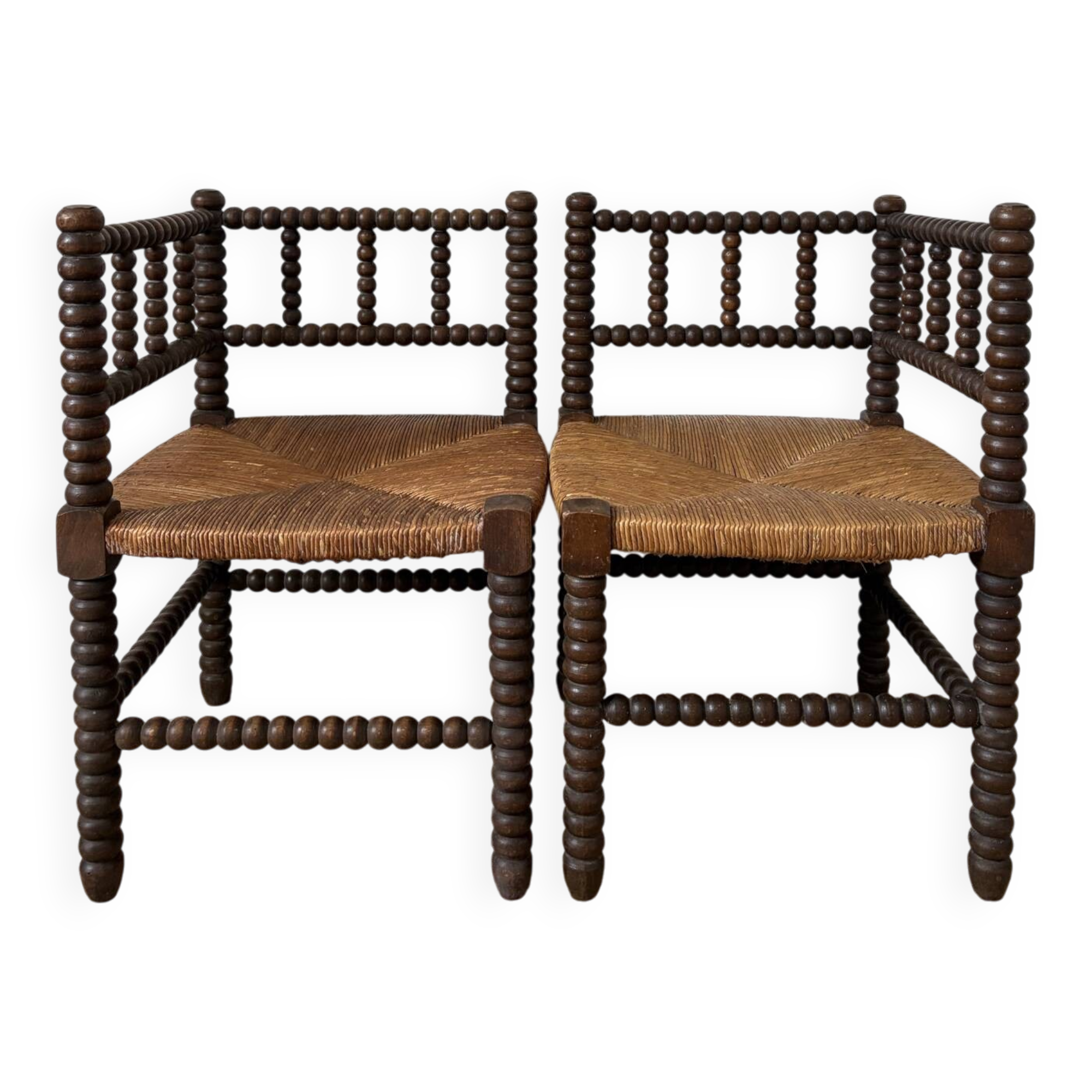 Pair of rush-seated chairs by the fireside "bobbin"