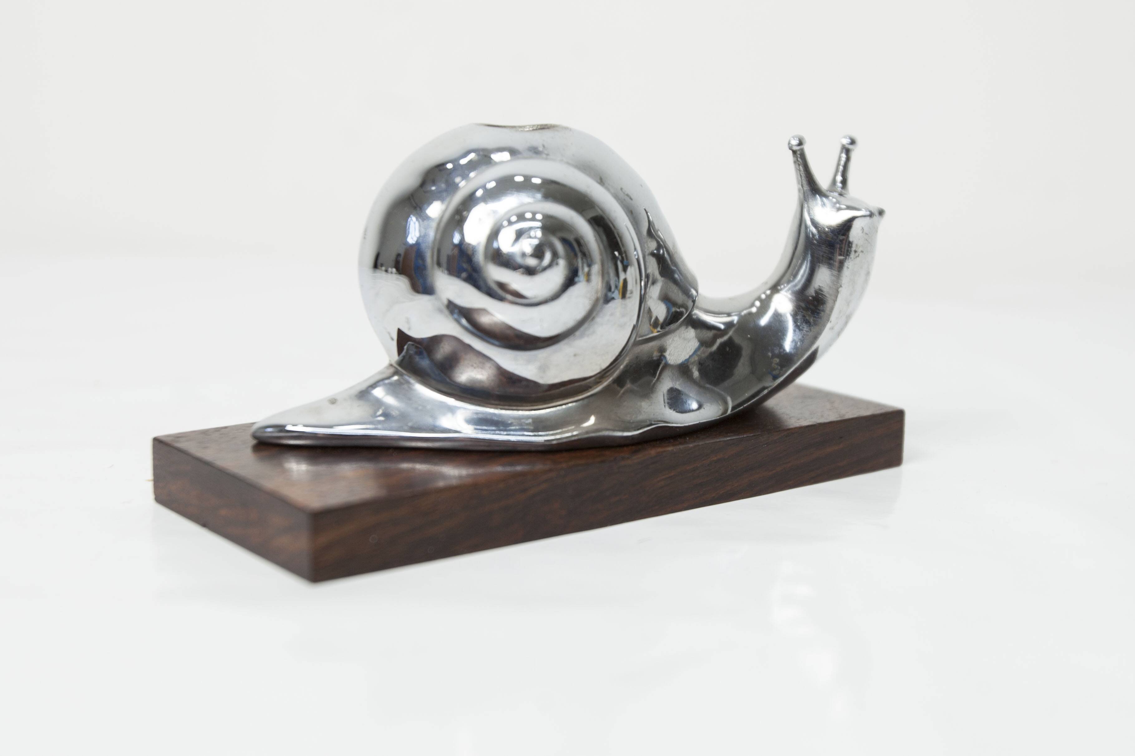 Silver snail candlestick on a teak base 1960