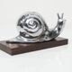 Silver snail candlestick on a teak base 1960