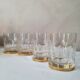 4 crystal whiskey glasses on gold frame
