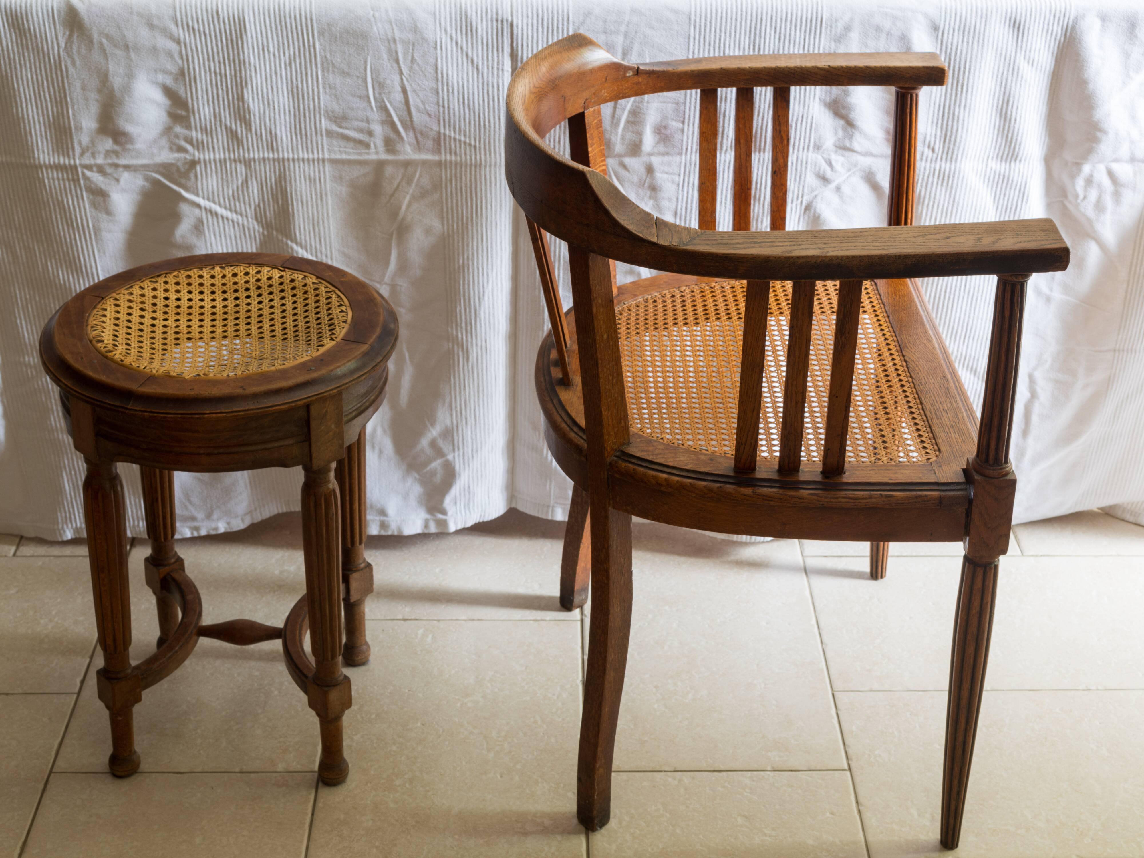 Antique armchair and stool with caned seat and fluted legs