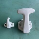 Two white porcelain coat hooks, one small and one larger, old